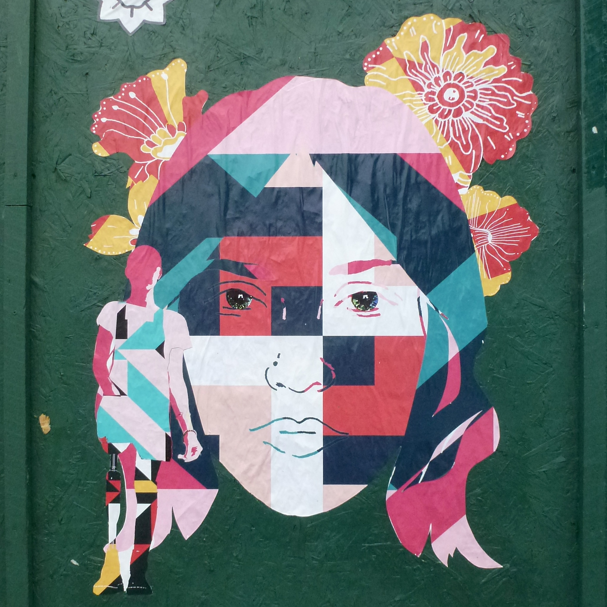 A mural featuring Ayla's silhouette and face that was designed collaboratively by artists in Wales and Indonesia, then pasted up in Cardiff.